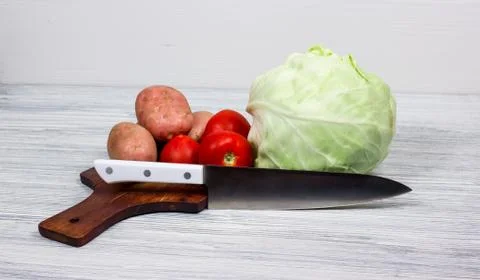 Kitchen, cooking, potato, knife, cutting board Stock Photos