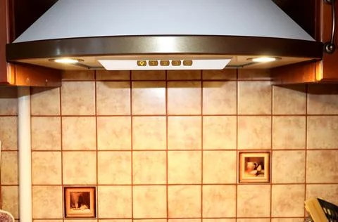 Kitchen corner with kitchen hood with lighting and tiles Stock Photos