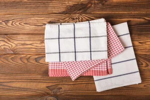 Kitchen cotton towels with a simple pattern folded on table Stock Photos