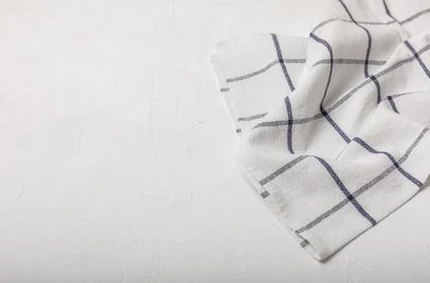 Kitchen cotton towels with a simple pattern folded on table Stock Photos
