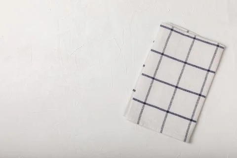 Kitchen cotton towels with a simple pattern folded on table Stock Photos