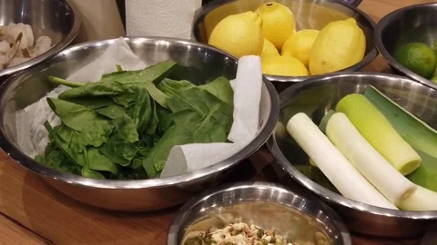 Kitchen counter prep with shrimp, lemons, and fresh greens Stock Footage 330138577