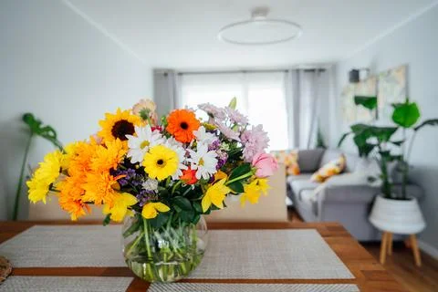 Kitchen counter table with focus on vase with huge multicolor various flower Stock Photos