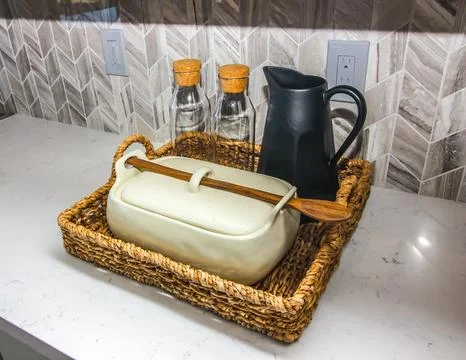 Kitchen Counter With Wicker Basket, Pitchen And Glass Containers Photos