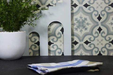 Kitchen Countertop Still Life With Patterned Tile, Folded Napkin and Potted Plan Stock Photos