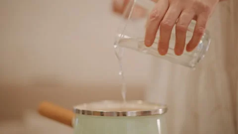 Kitchen culinary scene. Fingers dusted with flour preparing pumpkin filling Stock Footage 348300720