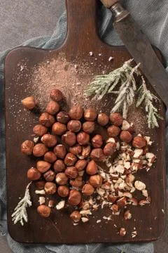 Kitchen cutting board with hazelnuts without shell, view from above. Stock Photos