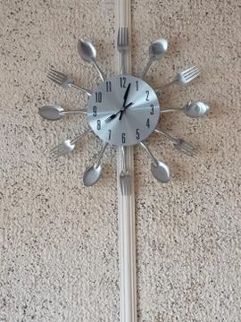 Kitchen decorative dersign clock witch spoons and forks Stock Photos