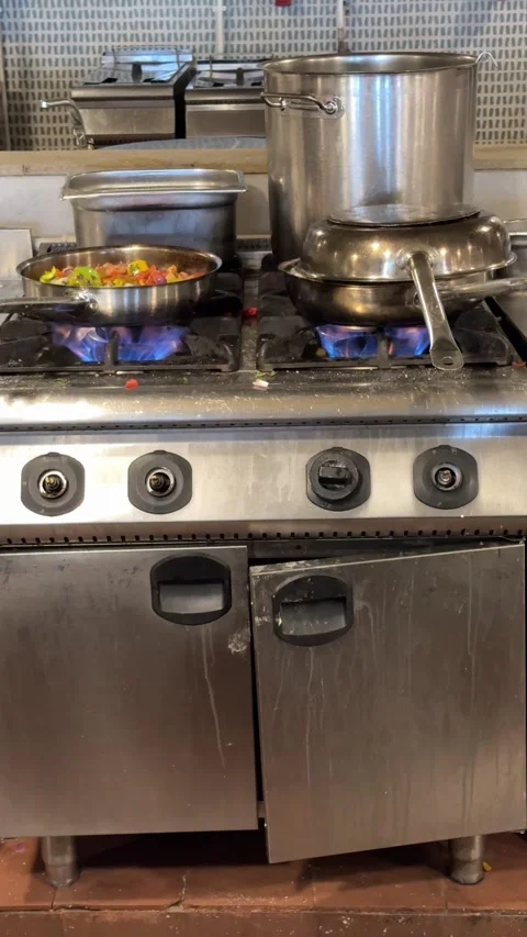 The kitchen in a dining hall is busy with chefs cooking and preparing dishes, Stock Footage 282801263
