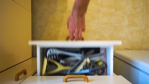 Kitchen draw full of messy utensils is opened, left open, and then closed. 스톡 동영상 105349114