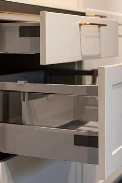 Kitchen drawer close up in modern interior. White minimal cabinet with gold.. Stock Photos