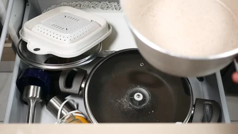 Kitchen drawer clutter with various cooking utensils and pots Stock Footage 303124001