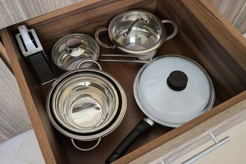 Kitchen drawer filled with metal cookware Stock Photos