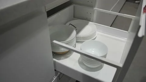 A kitchen drawer with white plates inside. 動画素材 179136463