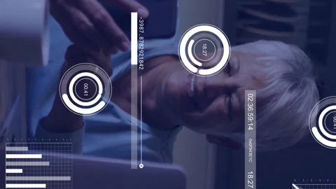 In kitchen, elderly woman using smartphone with animation of data analytics Stock Footage 313356261