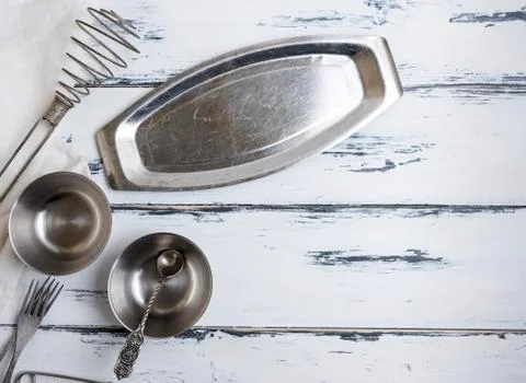 Kitchen empty metal objects on a white wooden background Stock Photos