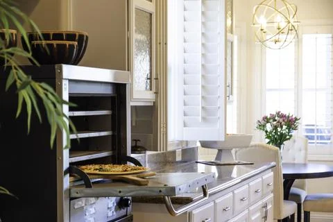 The kitchen features a microwave oven and a stove for cooking meals Stock Photos