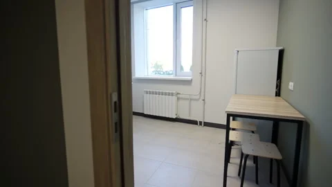 Kitchen features wooden dining table and matching stools Видео 332736939
