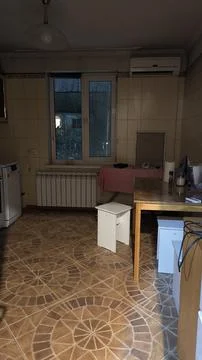 Kitchen featuring tiled walls, dining table and household appliances 스톡 사진