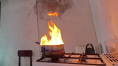 Kitchen fire safety hazard, oil pan fire explosion on stove, dangerous cooking Stock Footage 337724293