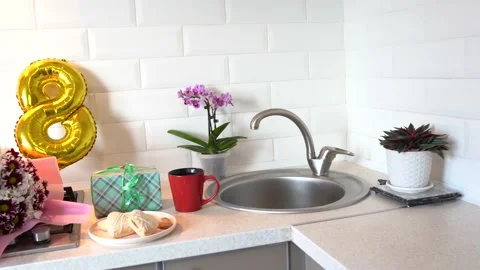 Kitchen with gift flower  and breakfast. Mothers Day. March 8, Women's Day Stock Footage 148951879