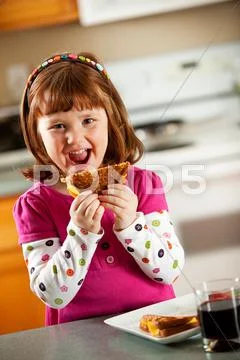Kitchen girl: having grilled cheese for lunch Stock Photos