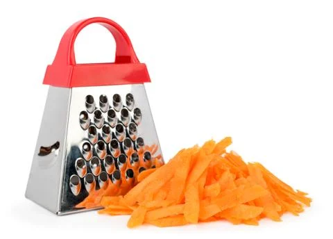 Kitchen grater and a bunch of grated carrots on a white, isolated. Stock Photos