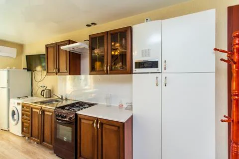 Kitchen in the guest house. Nice dark wooden furniture. Gas hob with extracto Stock Photos