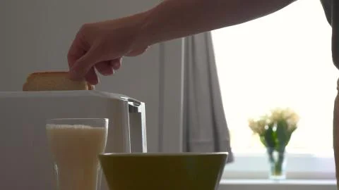 In the kitchen, a guy (girl) pulls out food from the refrigerator. Stock Photos