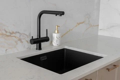 Kitchen interior with black faucet Stock Photos