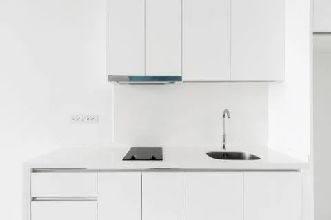 Kitchen interior concept. White counter with sink and electric stove, clear l Stock Photos