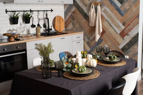 Kitchen interior design in rustic style with table ready for dinner Stock Photos