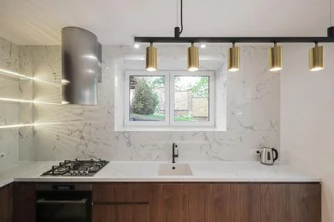 Kitchen interior with marble backsplash and window 스톡 사진