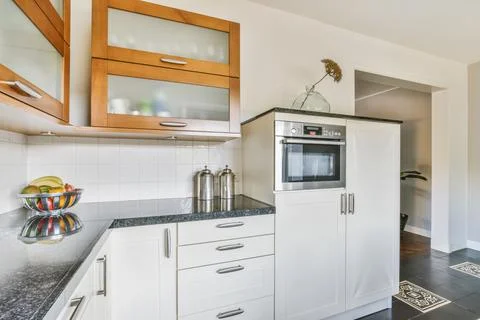 Kitchen interior with modern built in appliances in daytime Stock Photos