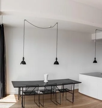 Kitchen Interior with table and black lamp over it. White Vase on the table Stock Photos