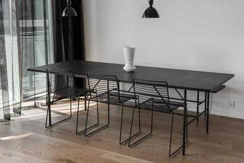 Kitchen Interior with table and black lamp over it. White Vase on the table Stock Photos
