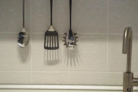 Kitchen interior. White wall and cutlery. Stock Photos