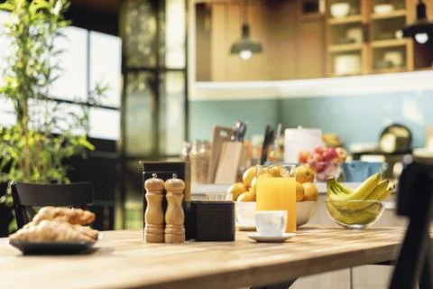 Kitchen interior, wooden breakfast table with pastry, empty home, natural light Stock Photos