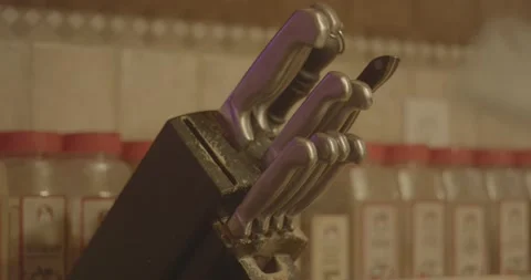 Kitchen knife being pulled out of knife rack holder Video stock 233314799