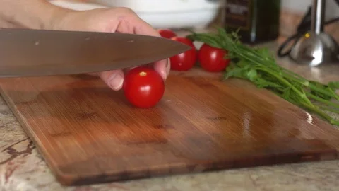 Kitchen knife cut fresh tomatoes cherry on wooden board. Healthy food cooking Stock Footage 116626809