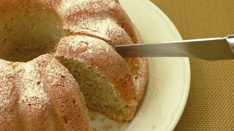 Kitchen knife is cutting a nut cake Stock Footage 73546386