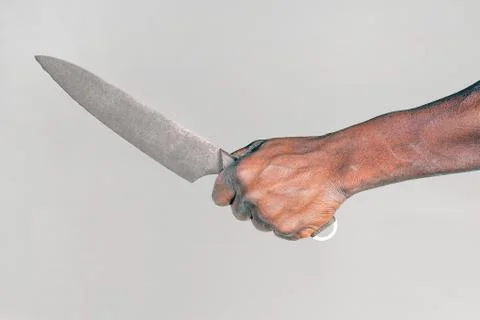 Kitchen knife in a hand. Big kitchen knife in african man hand. Stock Photos
