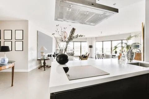A kitchen with a large island and a large window Stock Photos
