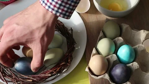 In the kitchen of male hands shift to a beautiful, colorful Easter eggs in a Stock Footage 148582997