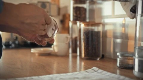 In the kitchen a man is busy preparing glass glasses using paper towels to c Stock Footage 323865140