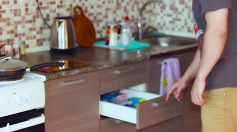 In the kitchen man searching for something 스톡 동영상 60230031