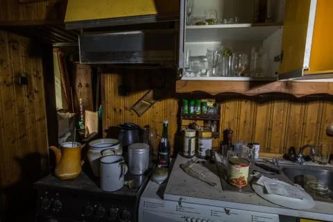 Kitchen with many old objects in a abandoned house Stock Photos