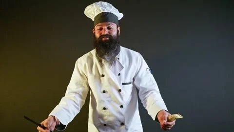 Kitchen master gestures with knife and banana explaining Stock Footage 304493024