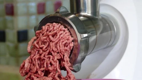 In the kitchen, the meat grinder is drawing meat, making minced meat, Stock Footage 101093053