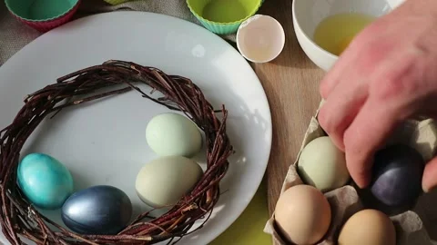 In the kitchen, men's hands move Easter eggs into a box Stock Footage 148582960